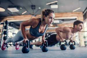Young,Couple,Is,Working,Out,At,Gym.,Attractive,Woman,And